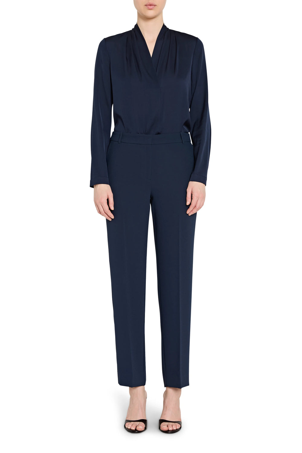 Navy blue jumpsuit worn by a model on a white background