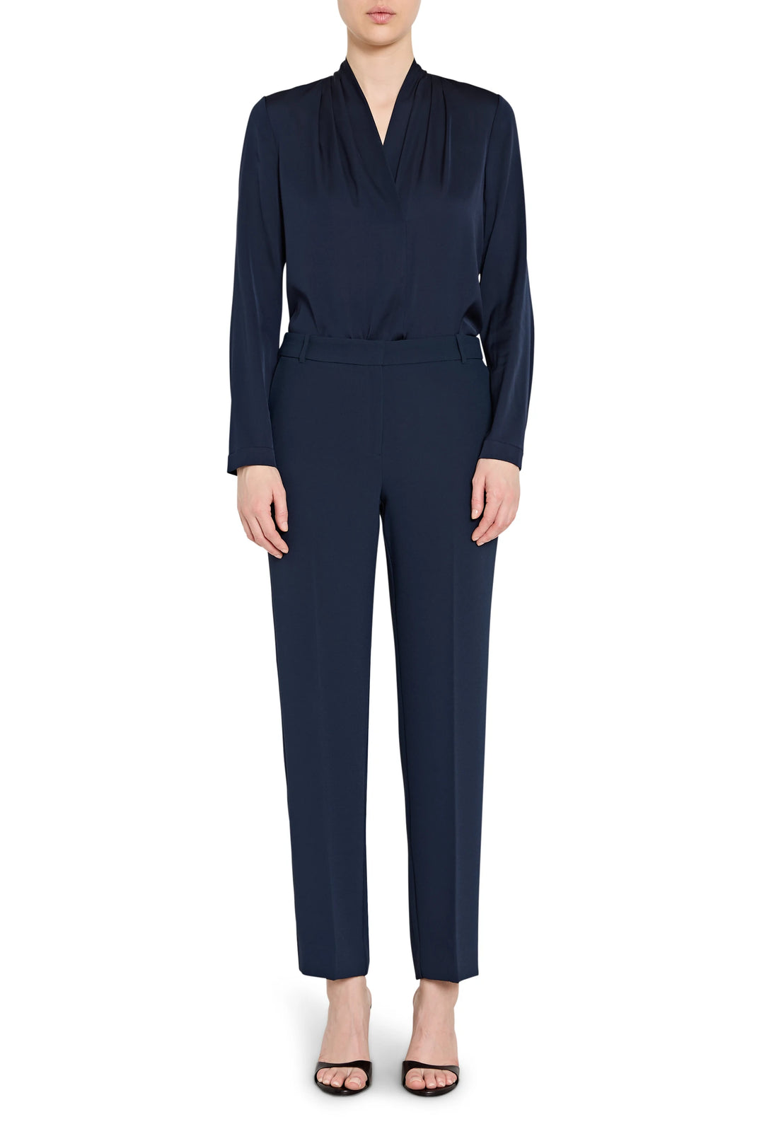 Navy blue jumpsuit worn by a model on a white background