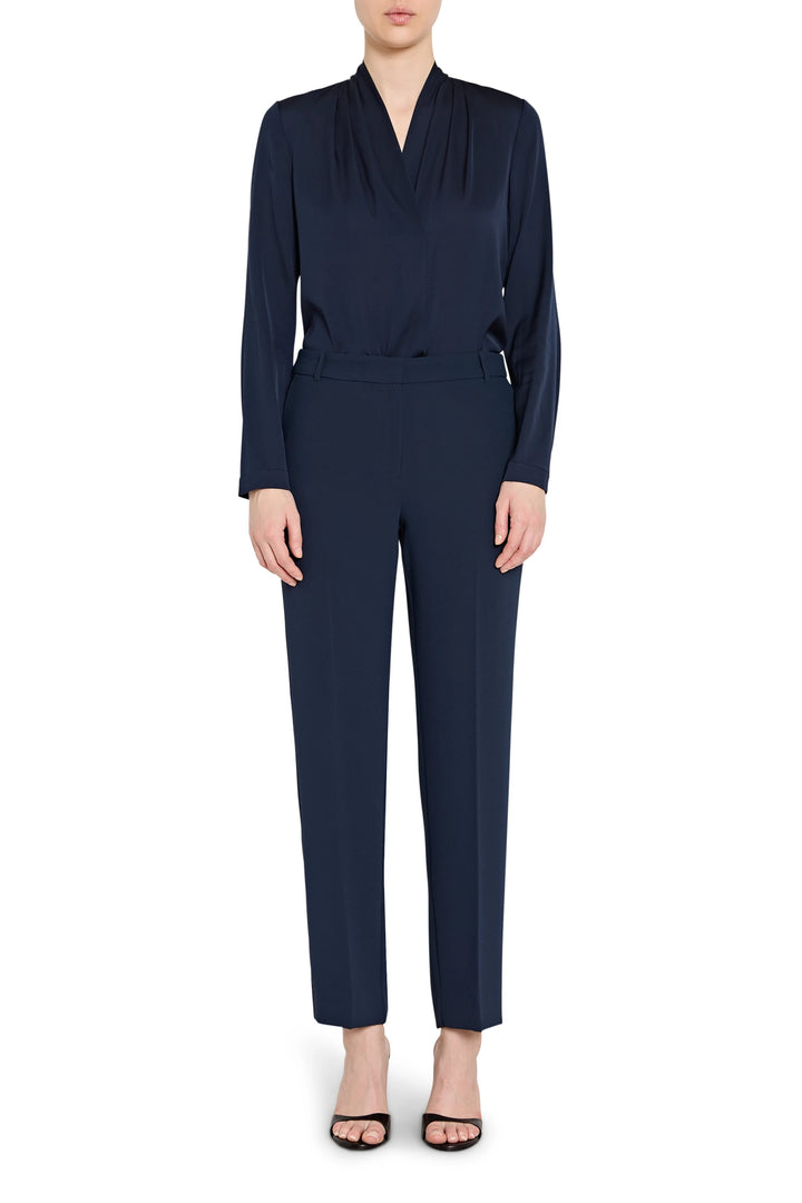 Navy blue jumpsuit worn by a model on a white background