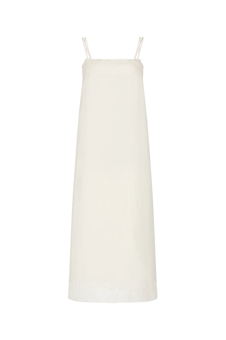 Ines Slip Dress in a midi, lingerie-inspired silhouette with thin straps and Chantilly lace hem, front view on white.