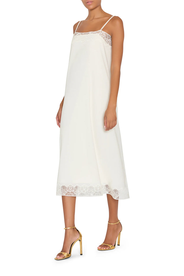 Ines Slip Dress, a lingerie-inspired midi silhouette with Chantilly lace trim, front view on model.