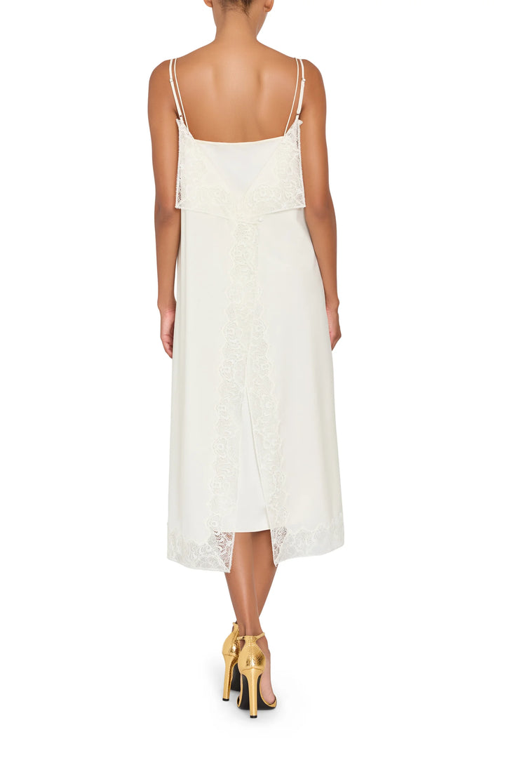 Ines Slip Dress, a midi silhouette with Chantilly lace trim at the back vent and hem, back view.