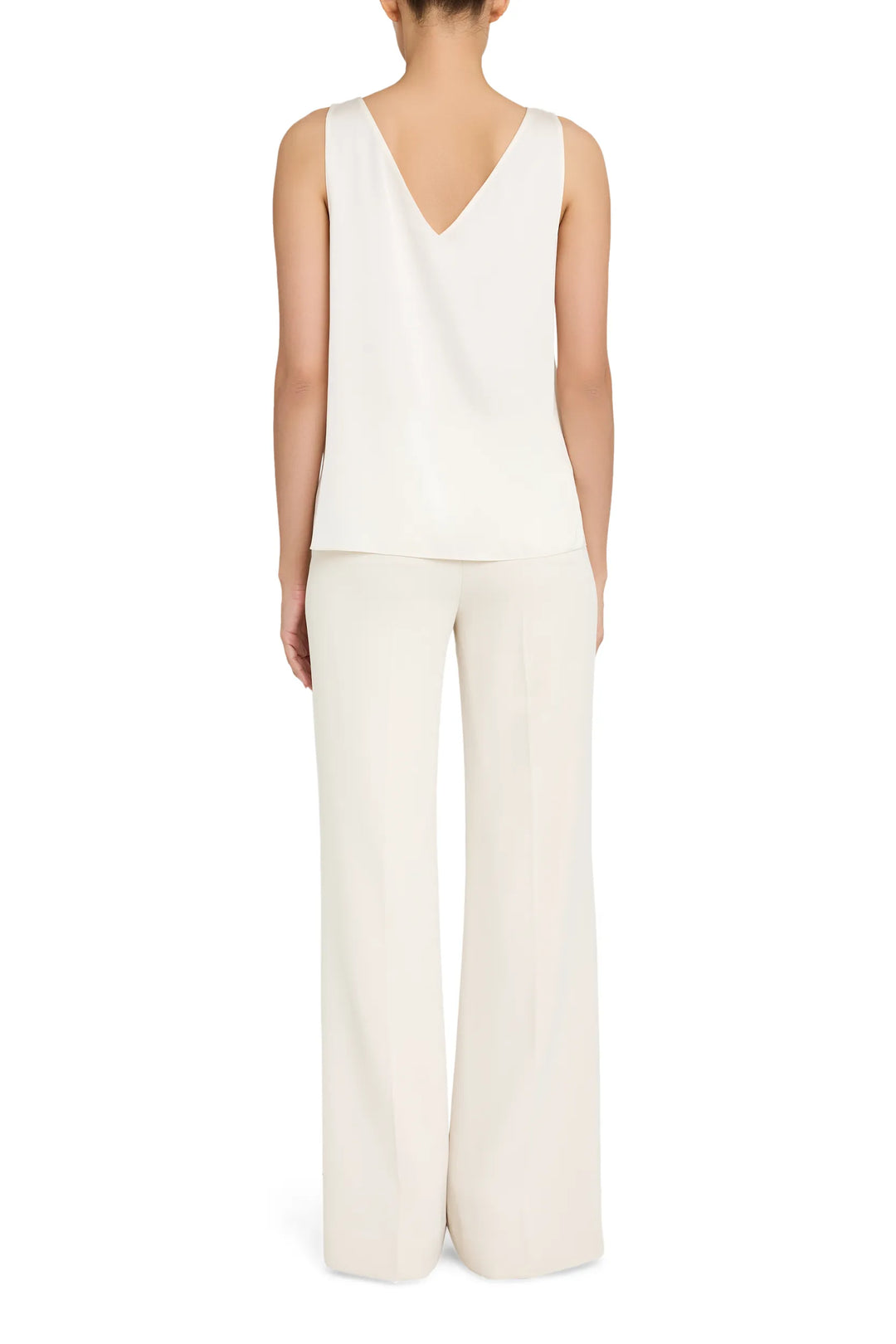 Sleeveless silk blouse, V-neck, clean lines and draped silhouette. Front view on model.