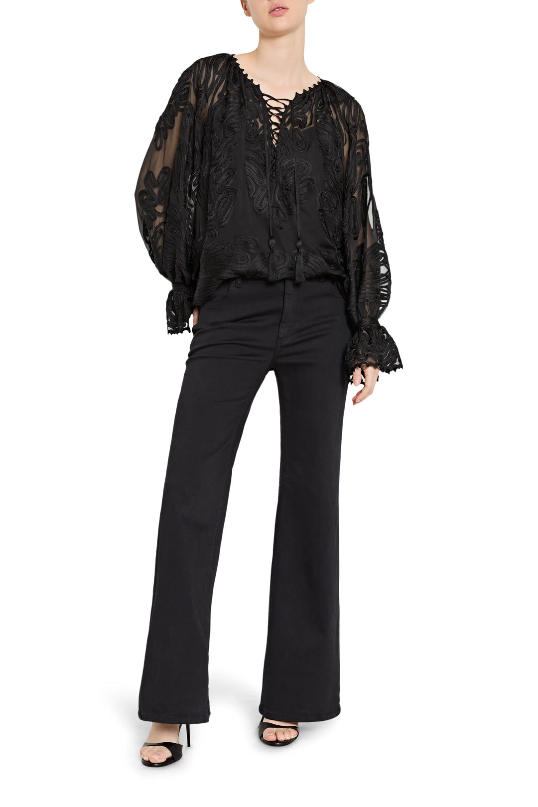 Black lace blouse and black pants on a white background