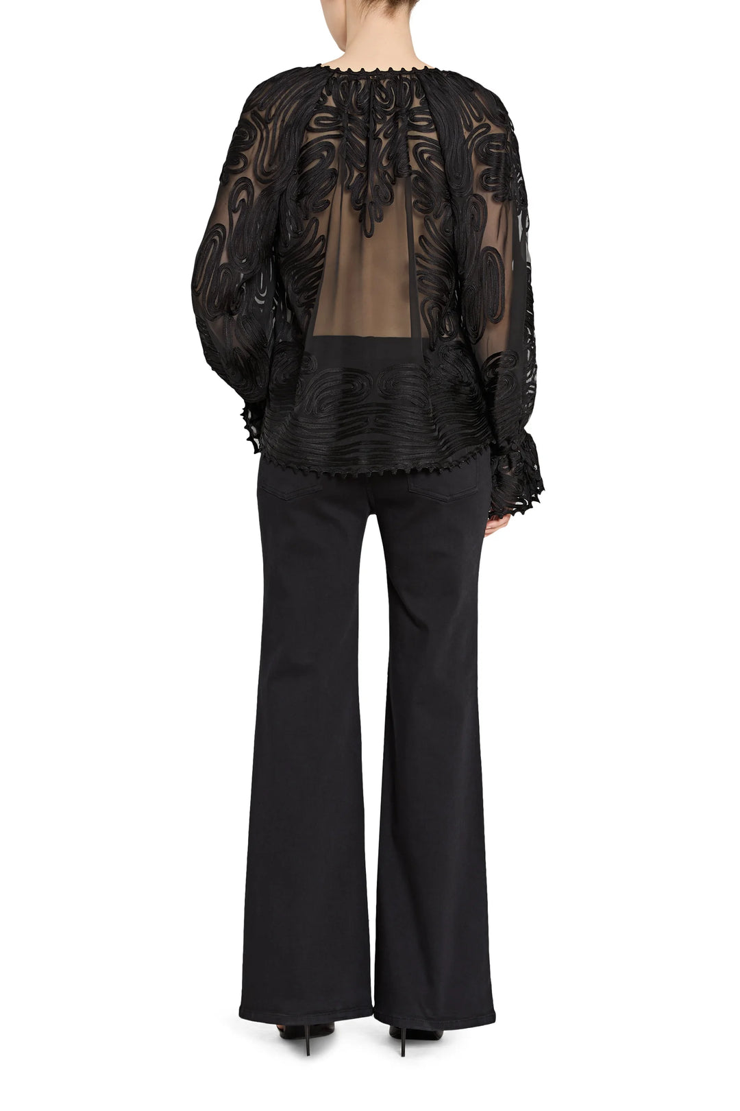 Black lace top and flared pants on a white background