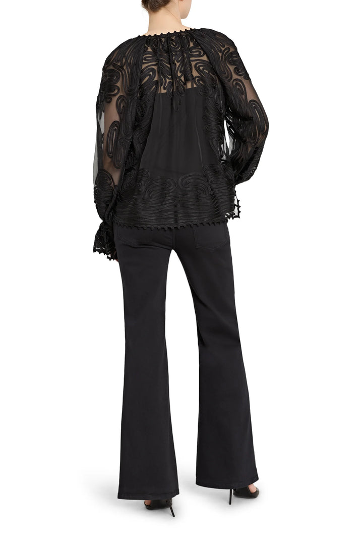 Black lace top and black flared pants on a white background