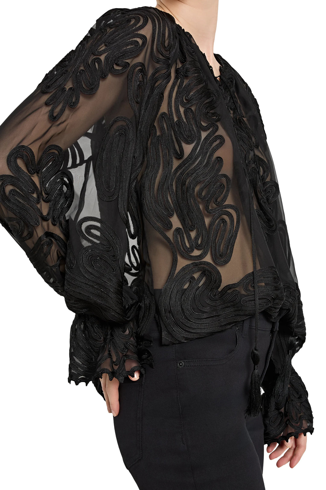 Black lace sheer top worn by a person on a white background