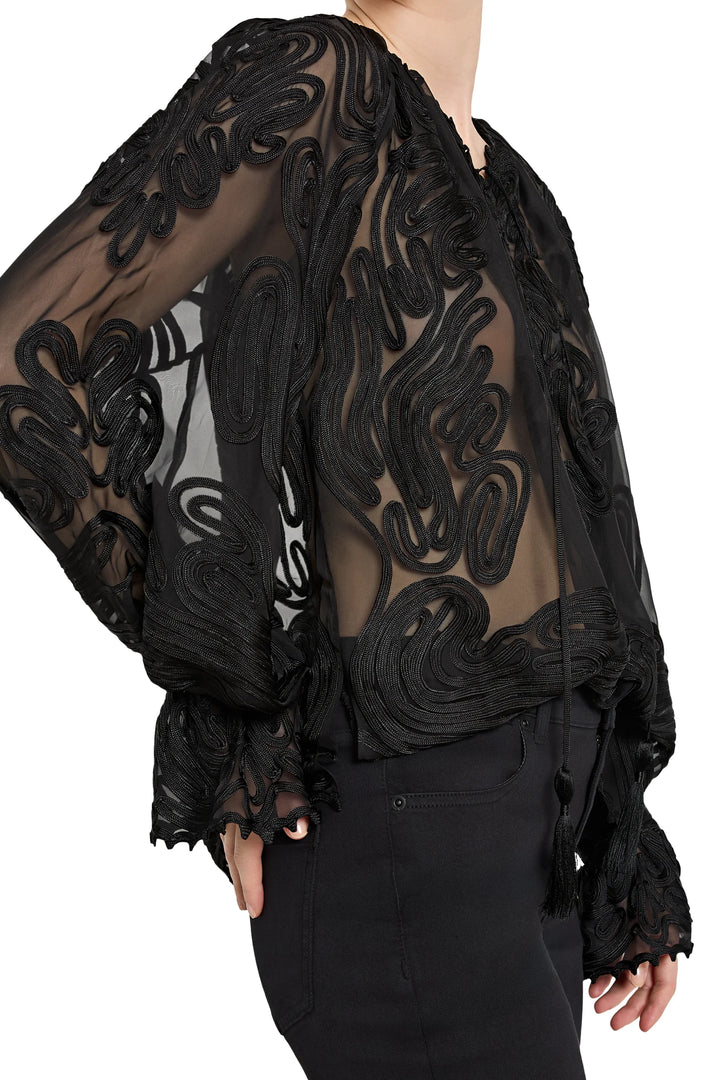 Black lace sheer top worn by a person on a white background