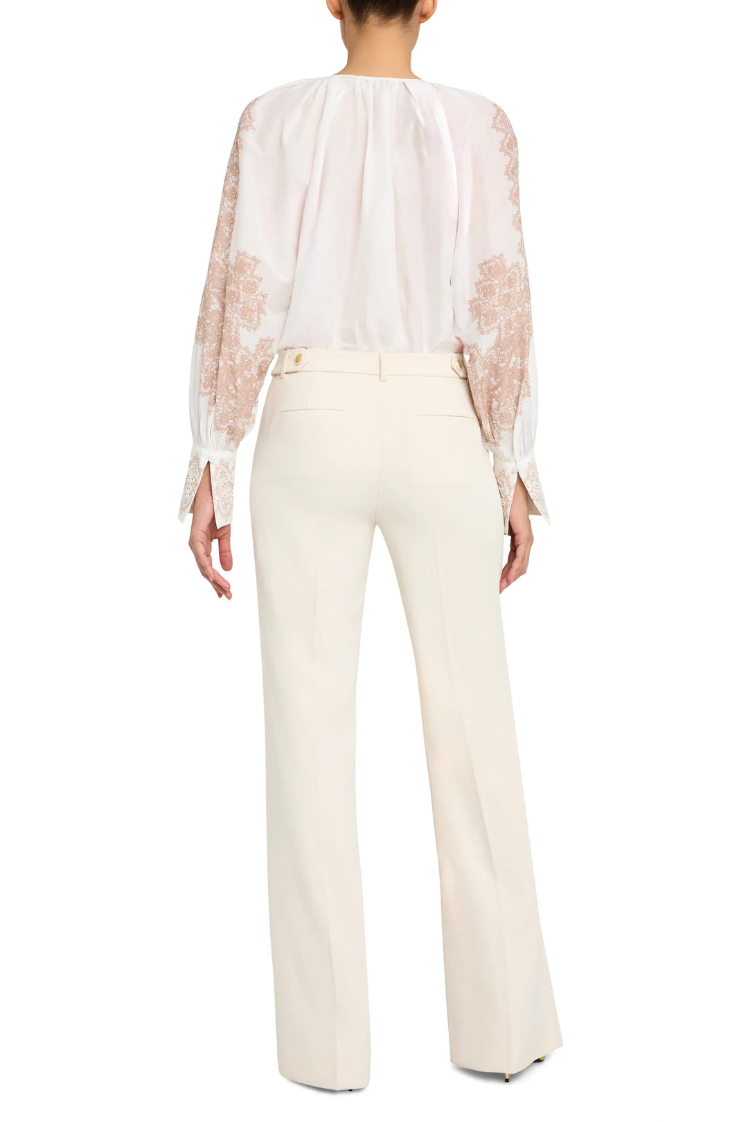 Hand-embroidered blouse with relaxed fit and detailed embroidery, back view on model.