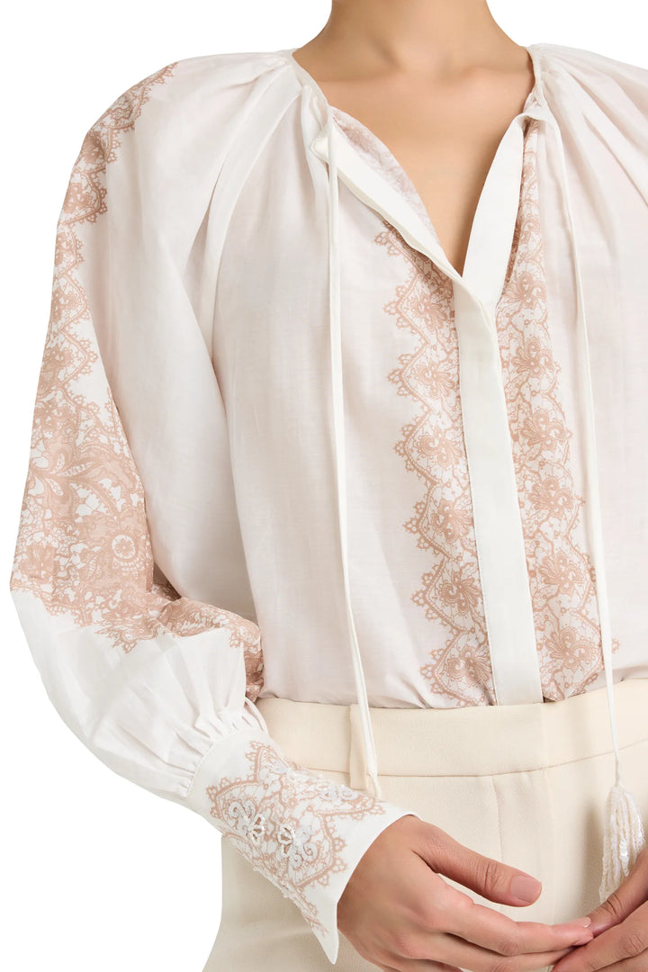 Blouse with relaxed silhouette, hand-embroidered details, pintucked bodice, cotton fabric; front view on model.