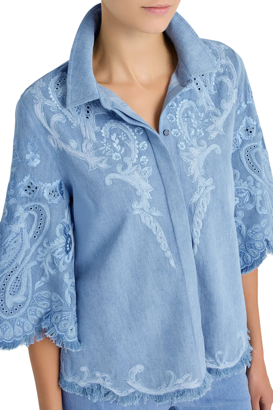 Boxy cotton blouse with artisan embroidery, scalloped and fringed sleeves and hem. Front view on model.