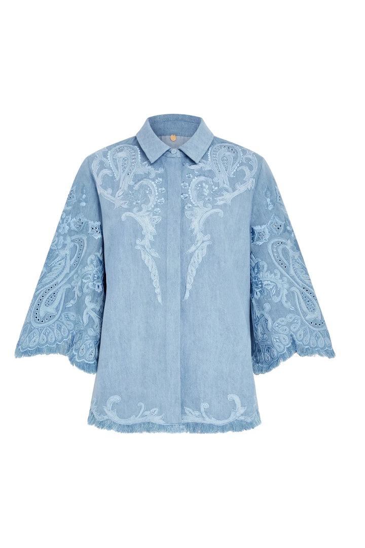 Light blue cotton blouse, hand-embroidered, wide 3/4 sleeves, frayed hem, button-up collar; front view on white.