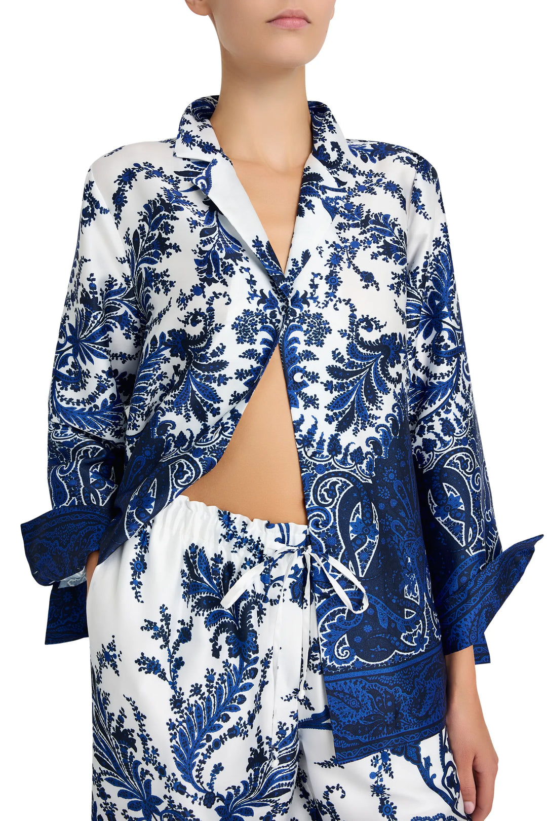 Long sleeve button-up blouse with curved hem, shirt collar, and floral print. Front view on model.