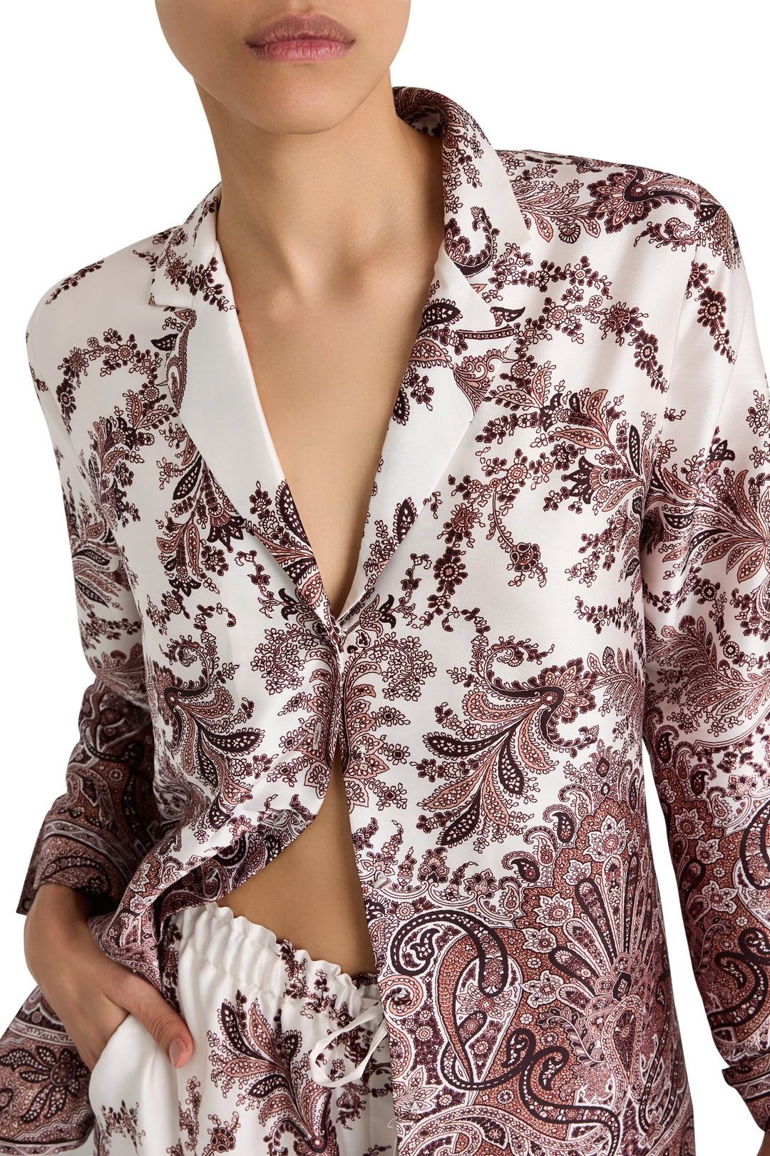 Relaxed fit blouse with long sleeves, button front, and shirttail hem in printed twill. Front view on model.