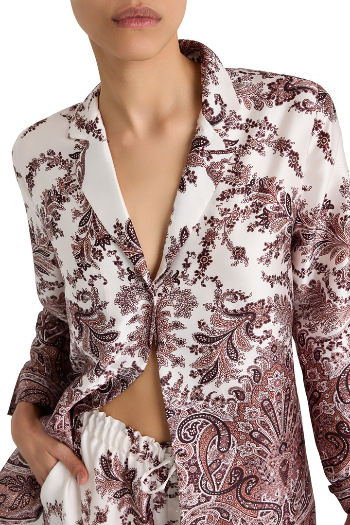 Relaxed fit blouse with long sleeves, button front, and shirttail hem in printed twill. Front view on model.