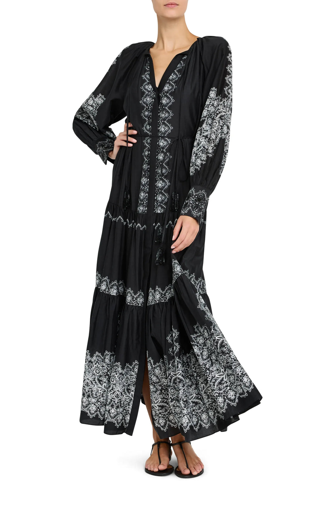 Maxi dress with long sleeves, fitted waist, fluid skirt, gathered cuffs; printed fabric. Front view on model.