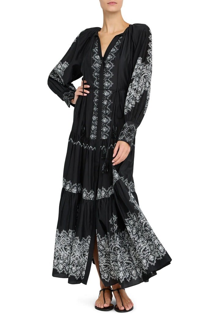 Maxi dress with long sleeves, fitted waist, fluid skirt, gathered cuffs; printed fabric. Front view on model.