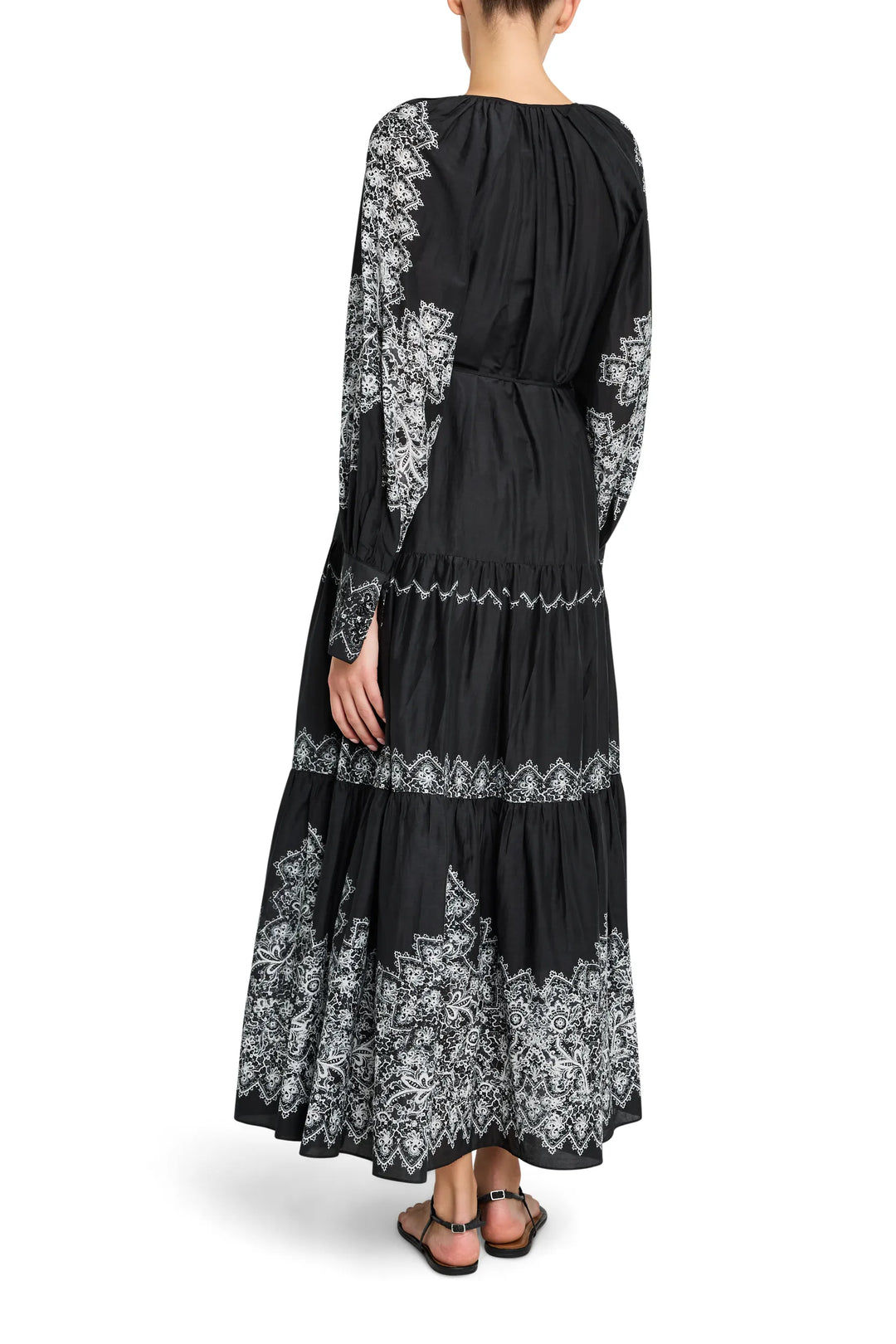 Maxi dress with flowing silhouette, antique lace print, soft gathers at waist. Back view on model.