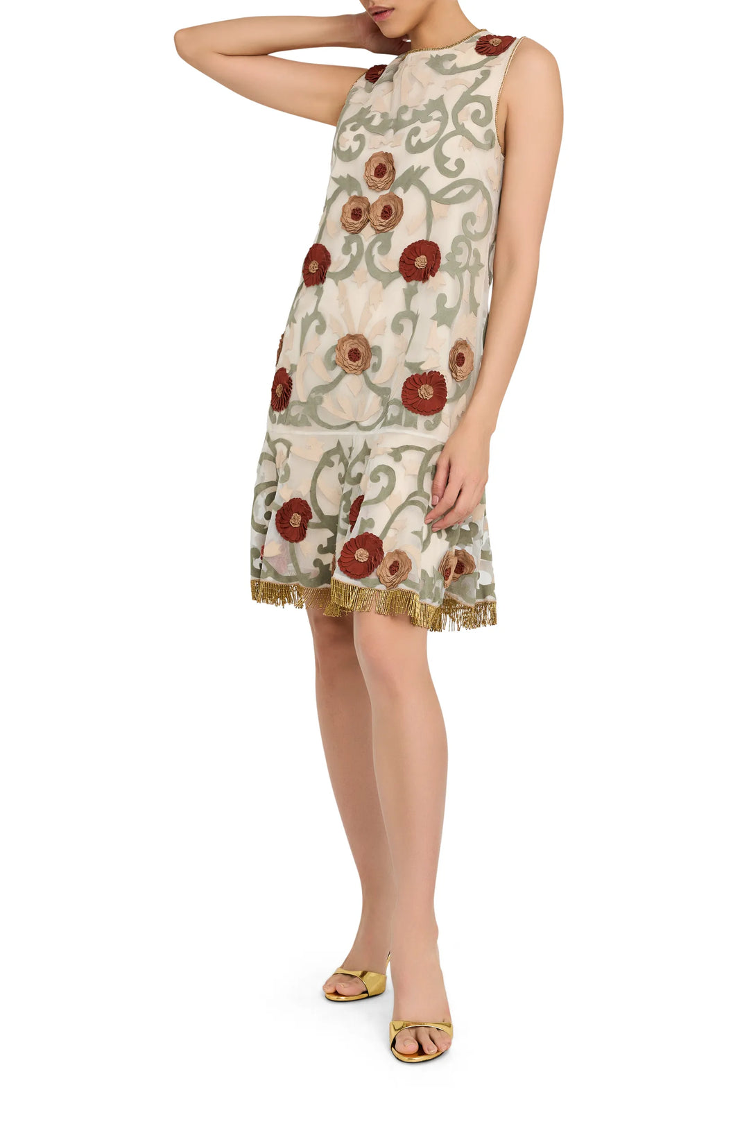 Mini dress with sleeveless organza silhouette, floral appliqué, and gold fringe hem. Front view on white.