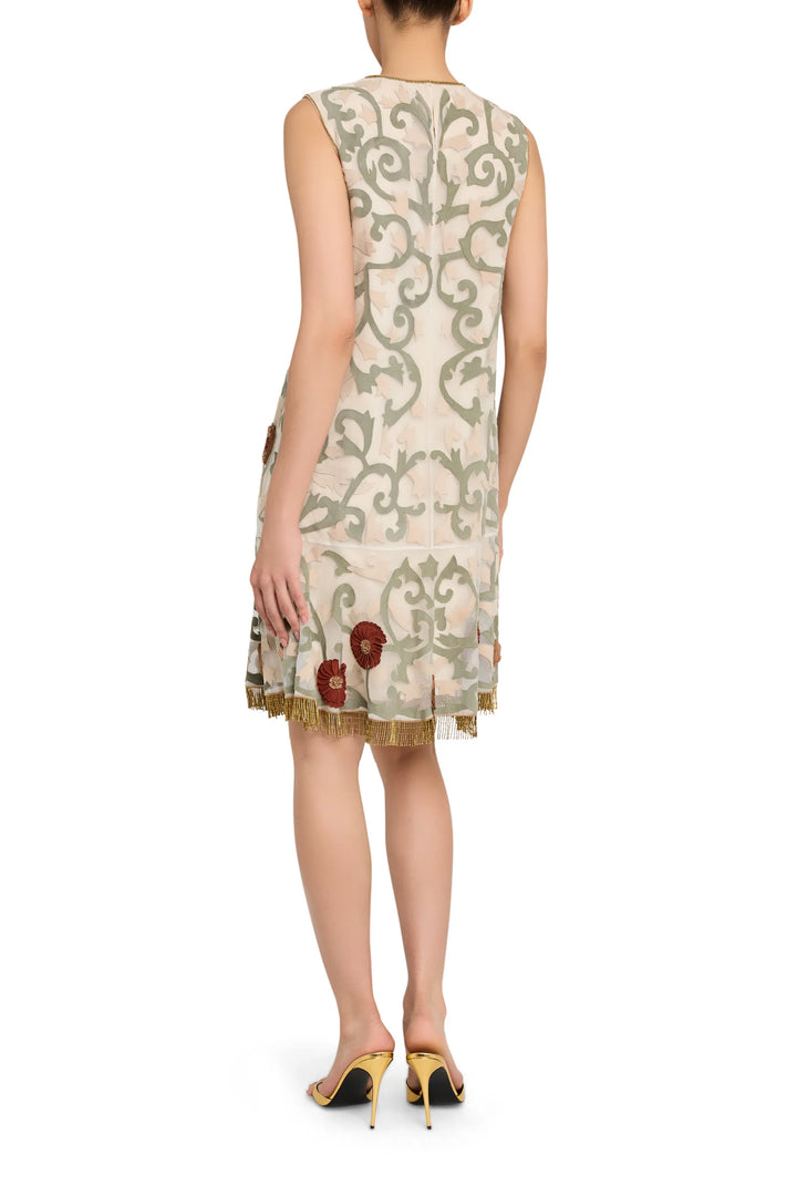 Mini dress in organza with sleeveless cut, back fringe trim and floral leather appliqué embroidery; back view on model.