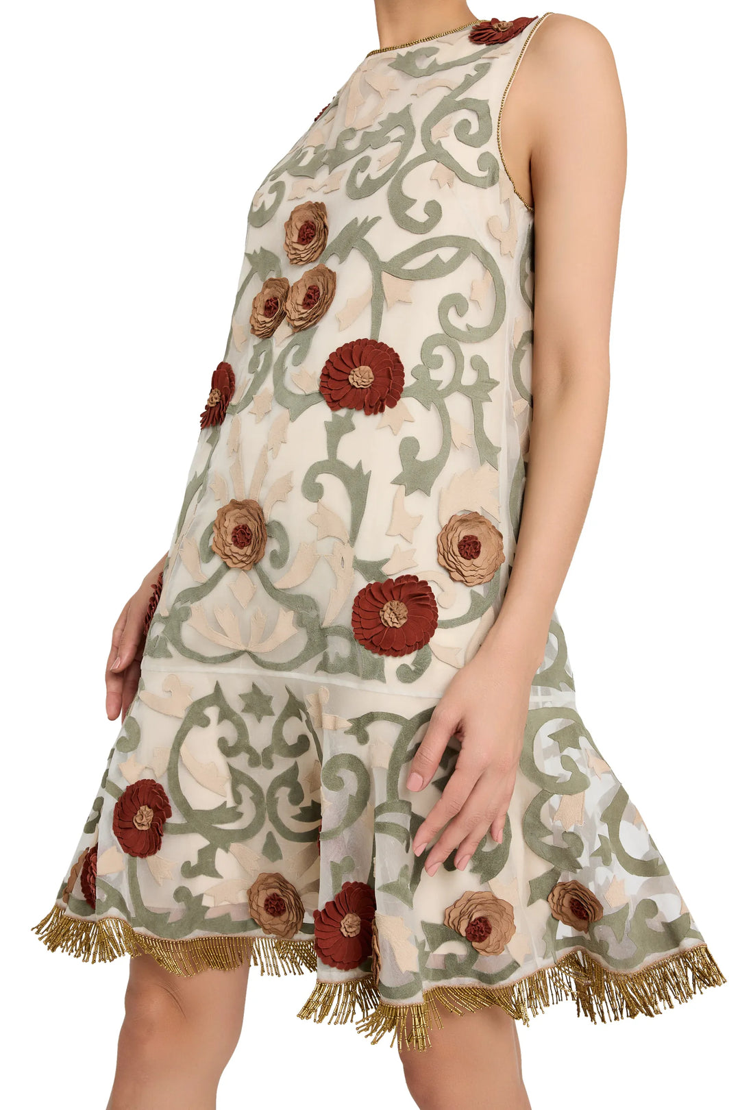 Sleeveless mini dress in organza with green swirl print, red floral appliqué, and gold fringe hem. Front view on white.
