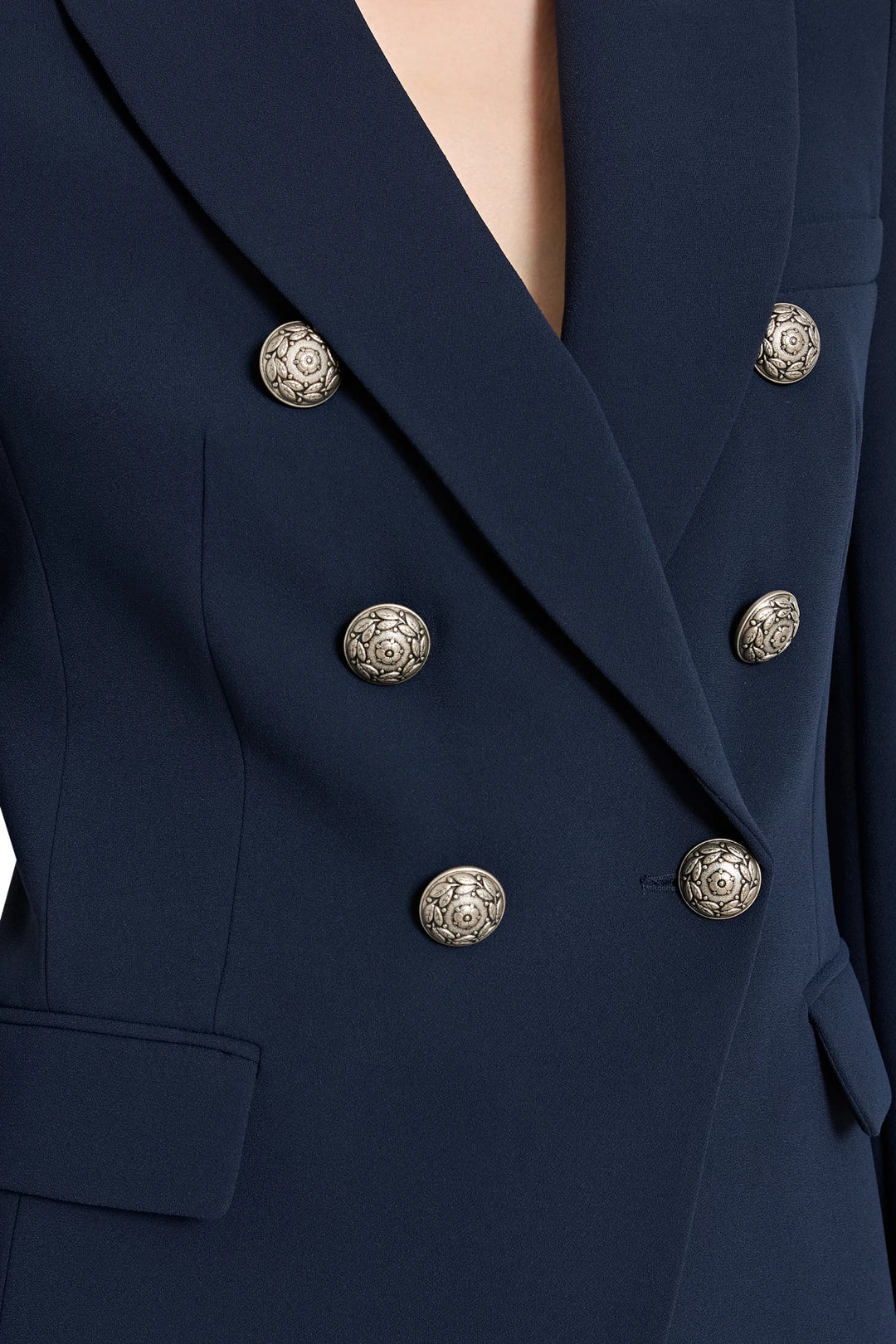 Navy blue blazer with gold buttons on a black background