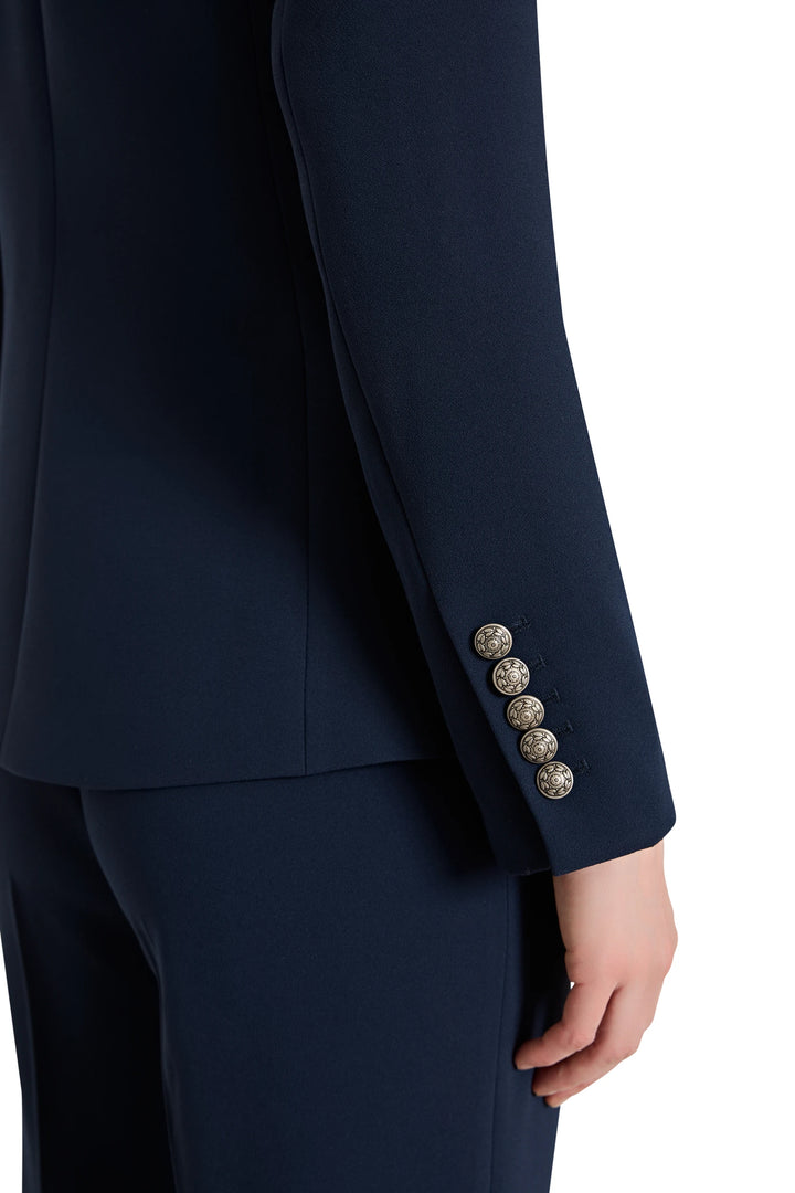 Navy blue suit with decorative buttons on a white background