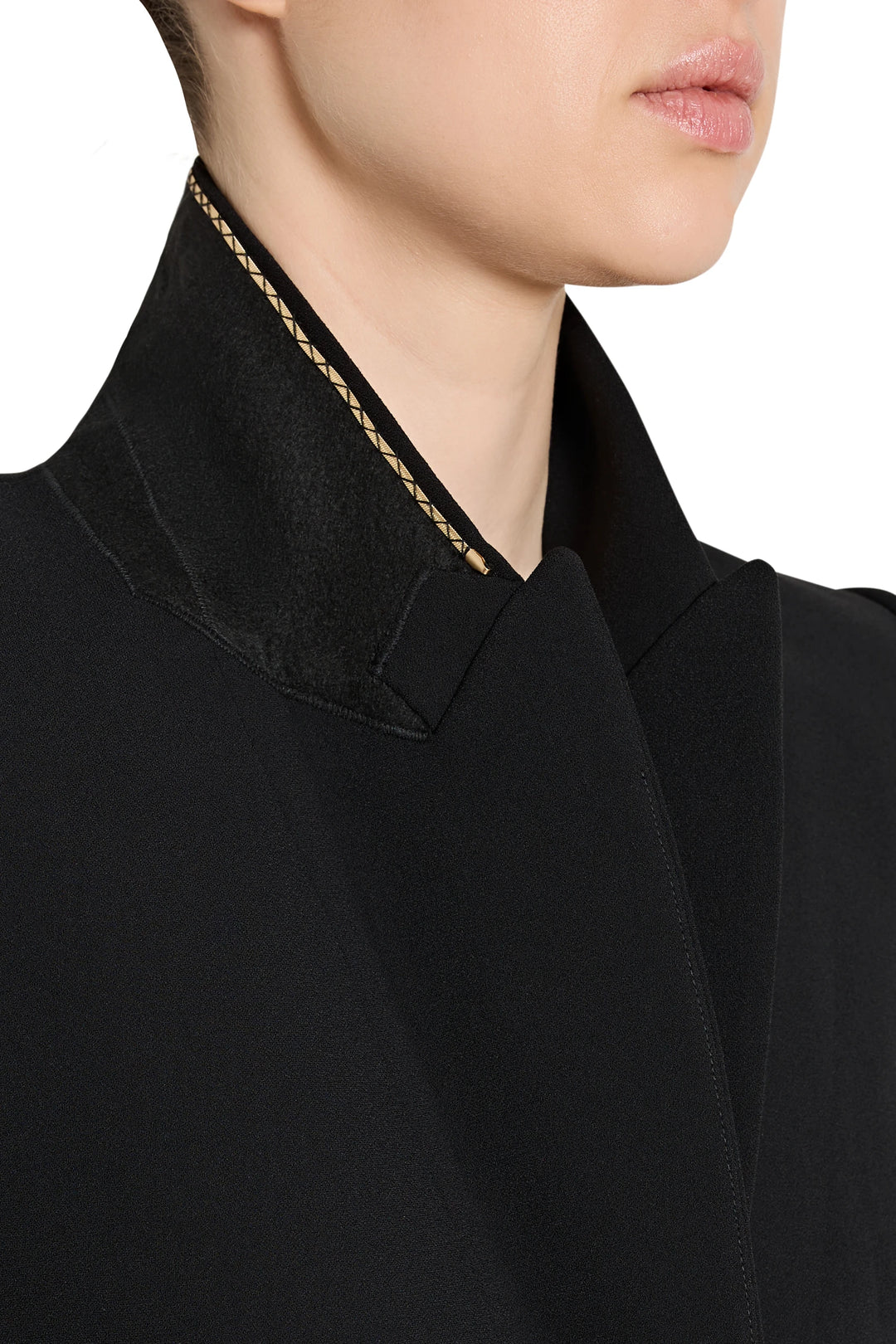 Close-up of a black garment with a textured trim on a white background