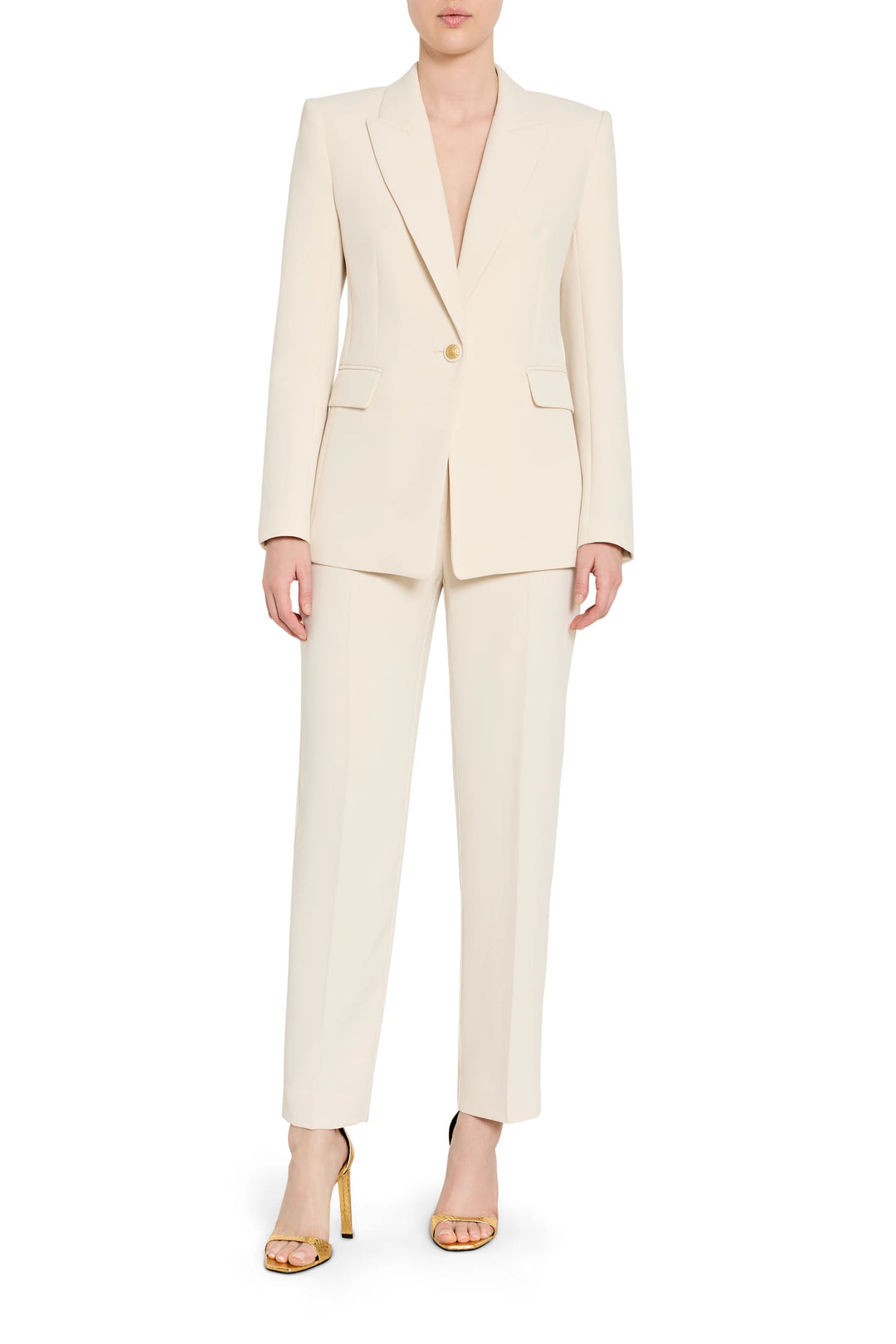 Woman wearing a cream suit on a white background