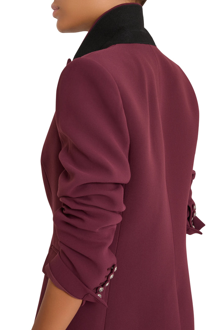 Crepe blazer with elongated silhouette, artisan buttons, ruched sleeves. Front view on model.