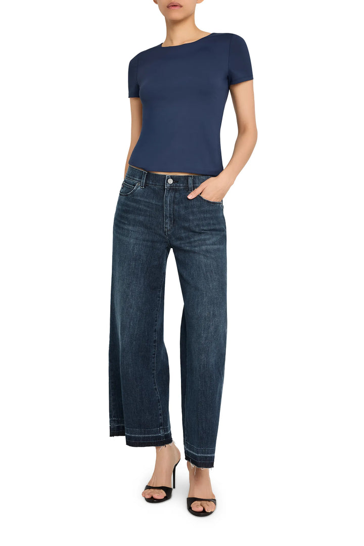 Fitted knit top with crew neck, long sleeves, and ribbed texture. Front view on model.