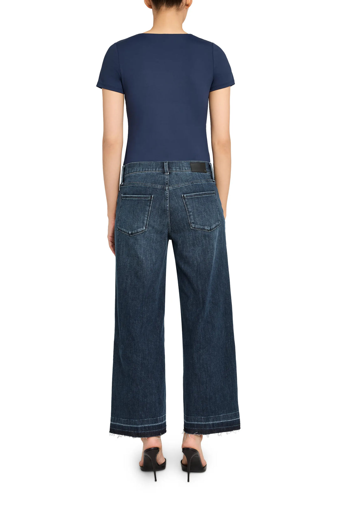 Relaxed silhouette knit top with clean lines, soft drape, and classic crewneck. Back view on model.