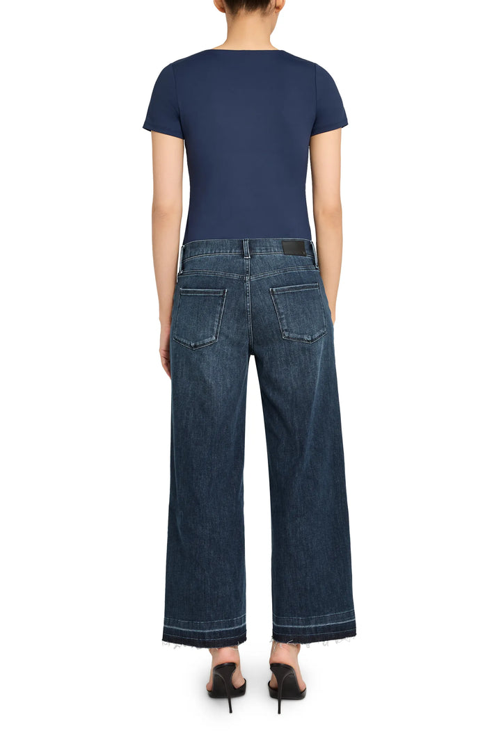 Relaxed silhouette knit top with clean lines, soft drape, and classic crewneck. Back view on model.