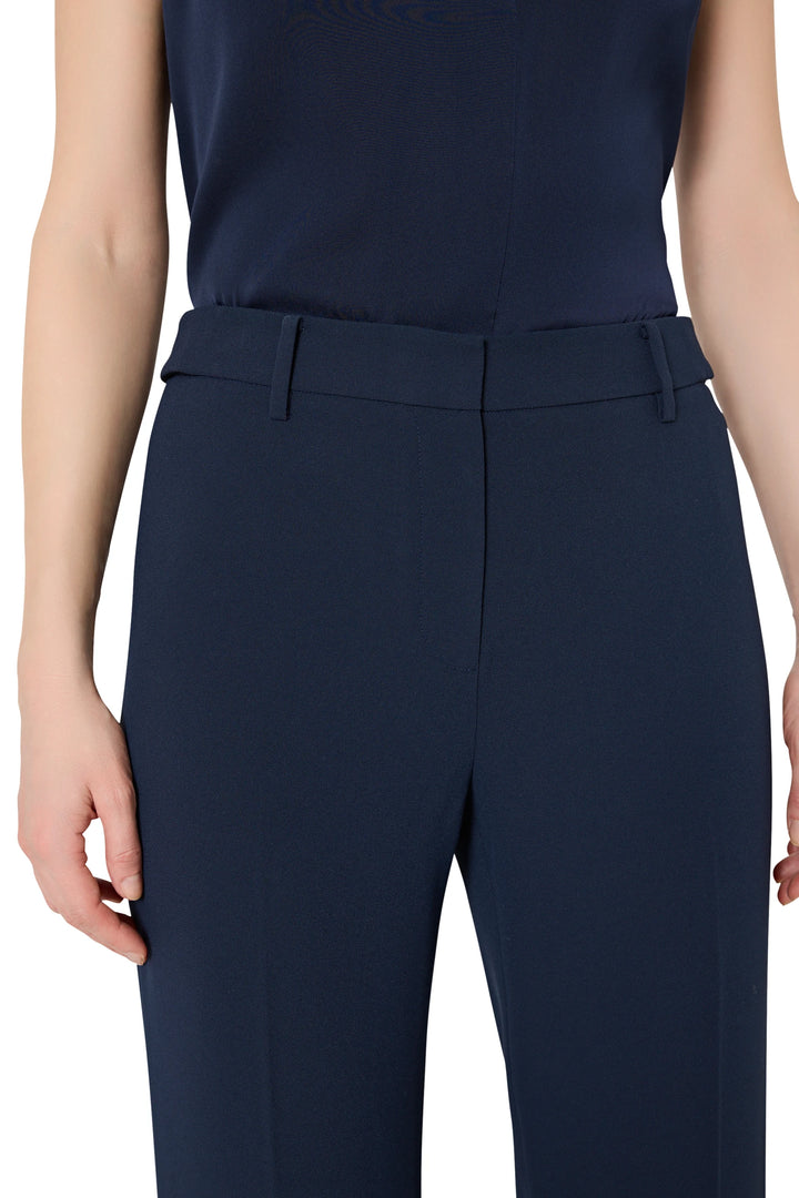 Navy blue pants worn by a person on a white background