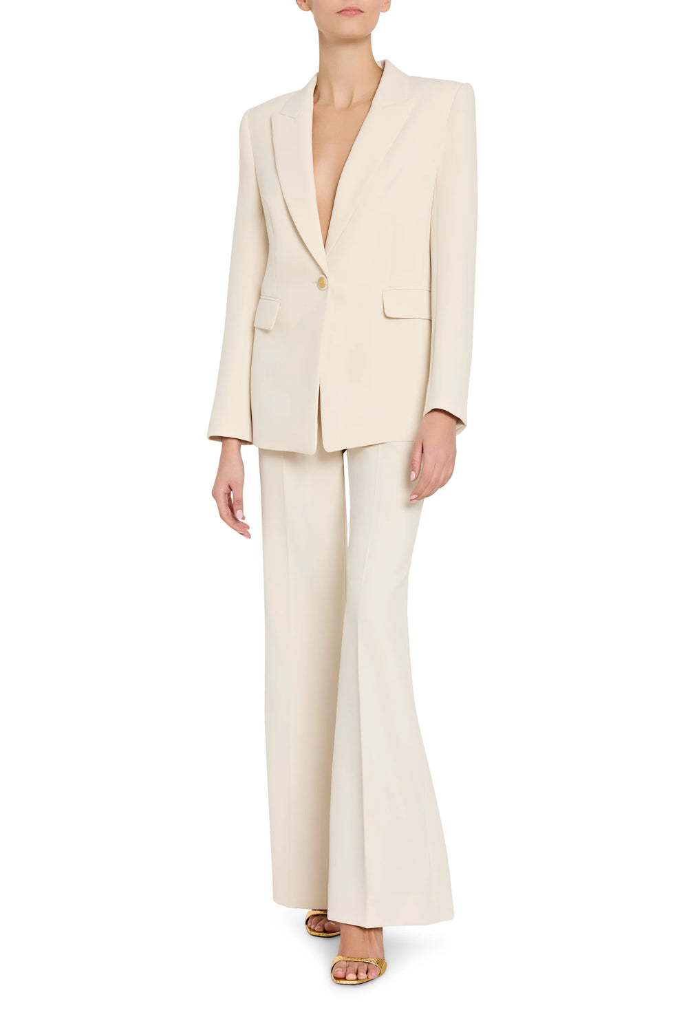 Person wearing a cream suit on a white background