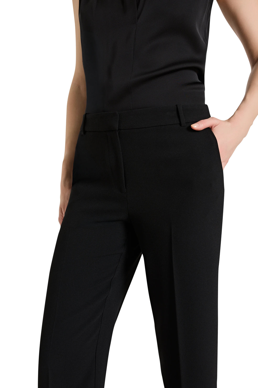 Black pants worn by a person on a white background