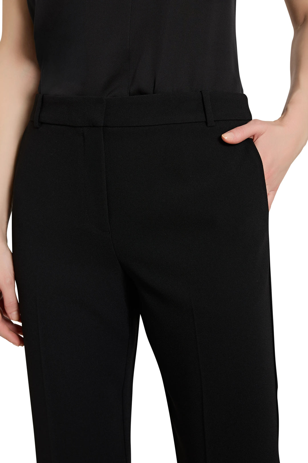 Black pants worn by a person on a white background