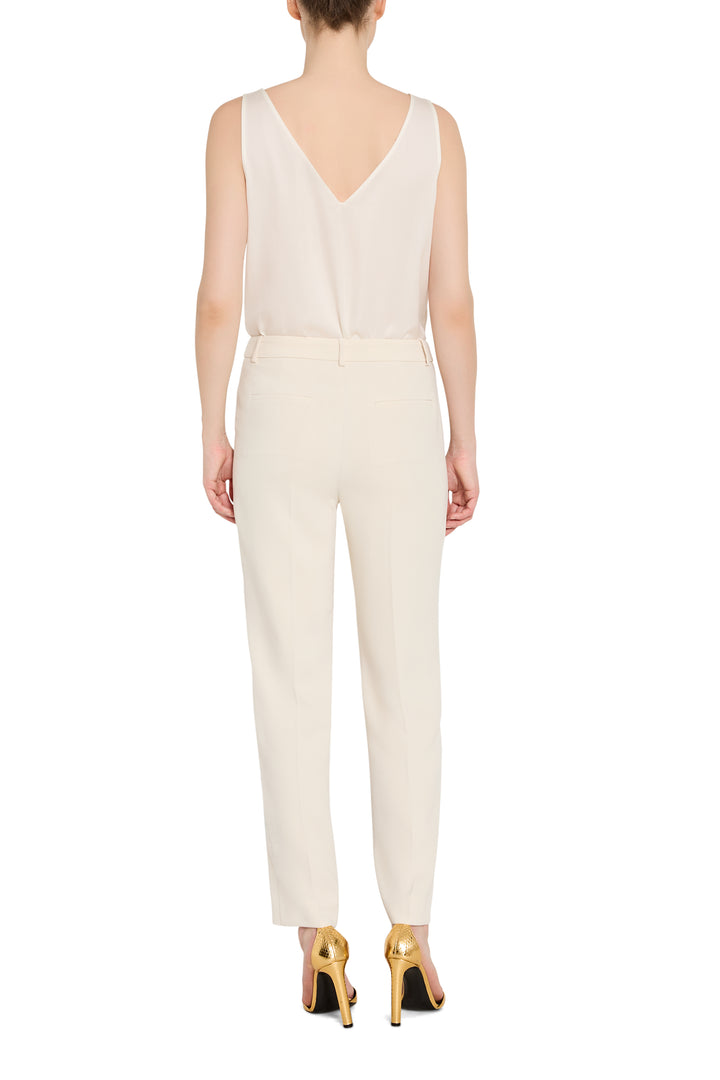 White jumpsuit worn by a model on a white background