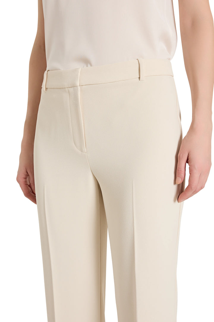 Beige pants worn by a person on a white background