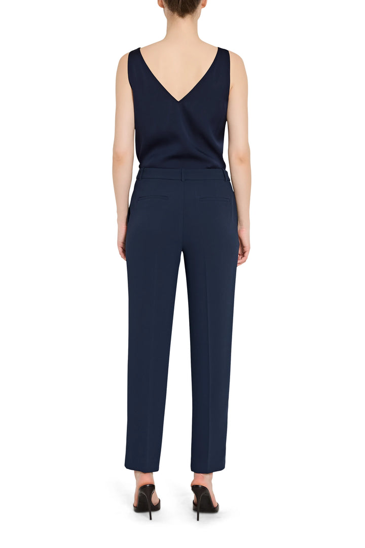 Navy blue jumpsuit worn by a model on a white background