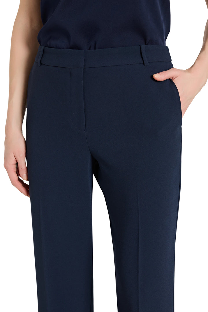 Navy blue pants worn by a person on a white background