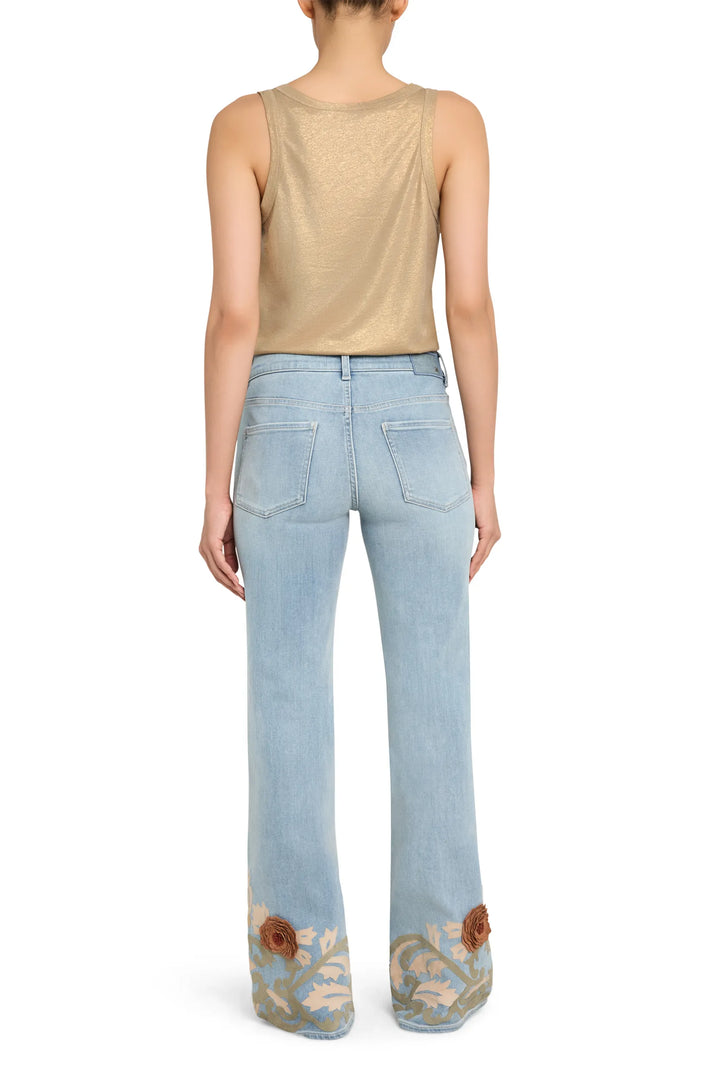 Wide-leg vintage-wash denim jean with embroidered appliqué hems, classic pockets and waistband; back view on model.