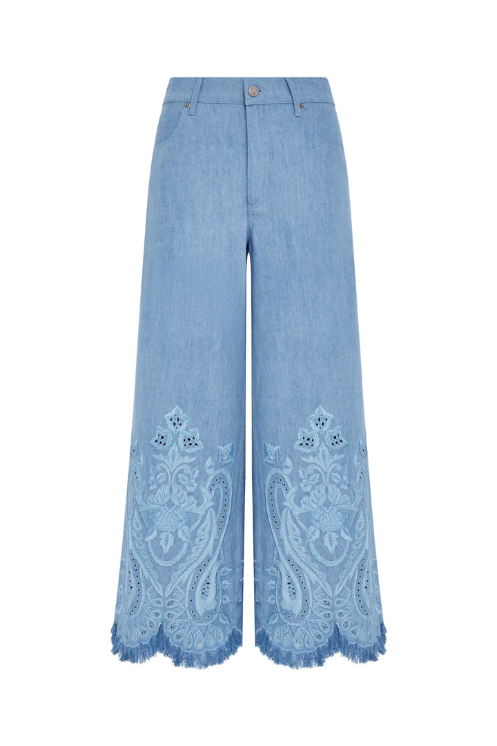 Cropped jean in light blue cotton with hand-embroidered marigold motifs, scalloped fringed hems; front view on white.