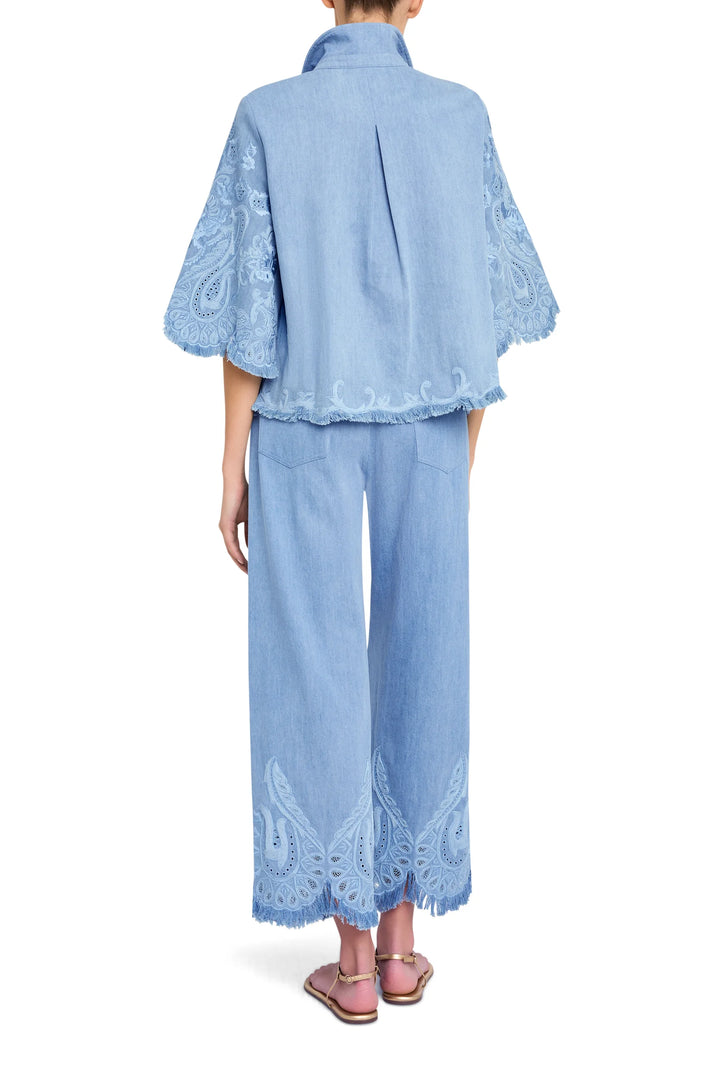 Relaxed-fit blouse with hand-embroidered floral details on denim, straight hem; back view on model.