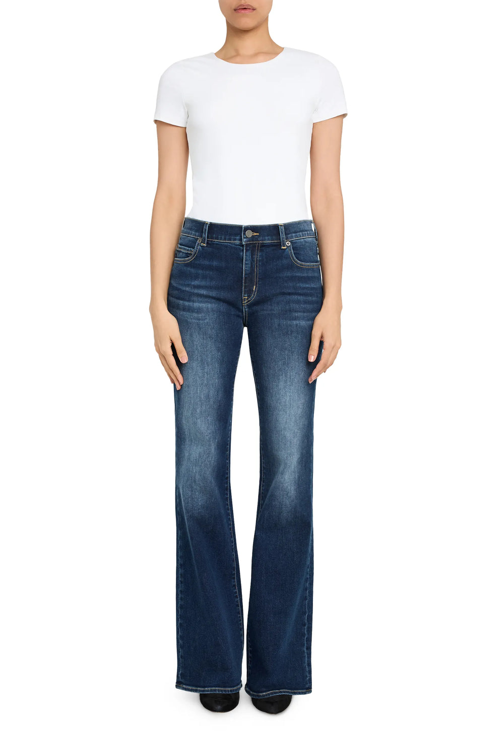 Flared wide-leg denim jeans with structured fit and classic seams, ankle length, front view on model.