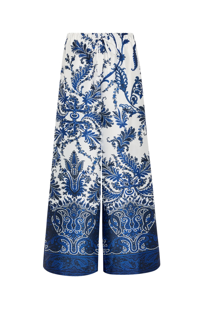 Wide-leg twill pants with elastic waist, paisley and floral print. Silky drape and smooth finish. Front view on white.