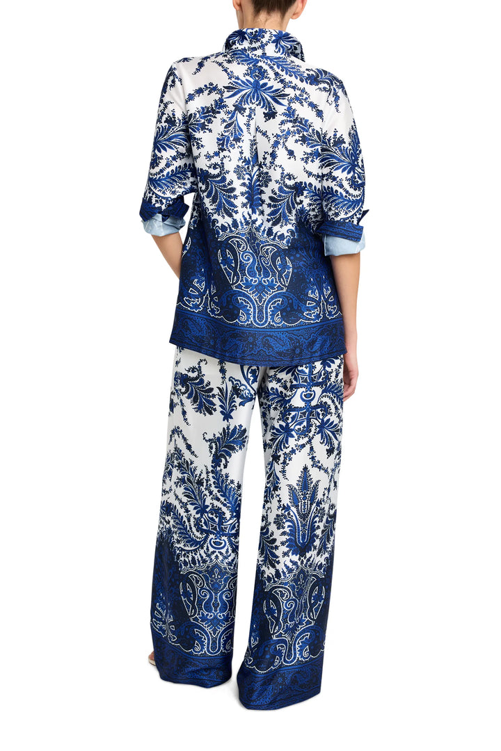 Wide-leg twill pants with tailored waistband and straight hem, fluid silhouette; back view on model.
