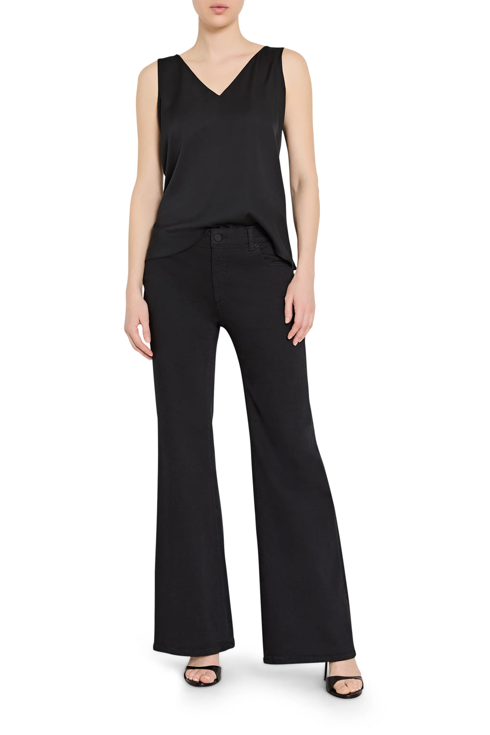 Woman wearing a black sleeveless top and wide-leg pants on a white background
