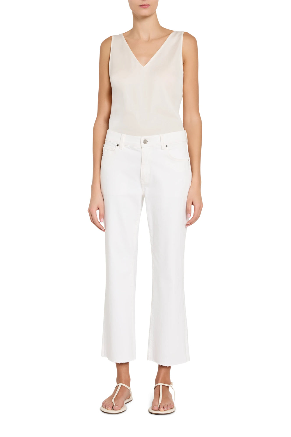 Person wearing a white sleeveless top and pants on a white background