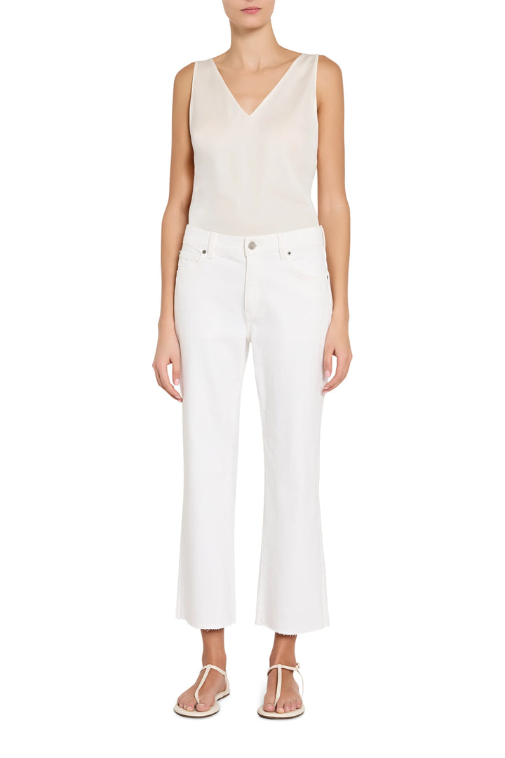 Person wearing a white sleeveless top and pants on a white background